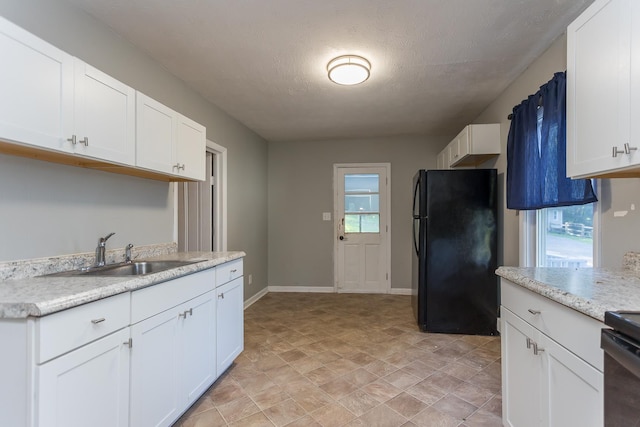 99 Sharp Hill Ln, Hinton, VA 22831 - kitchen with freestanding refrigerator, white cabinetry, stone finish flooring, a textured ceiling, and range