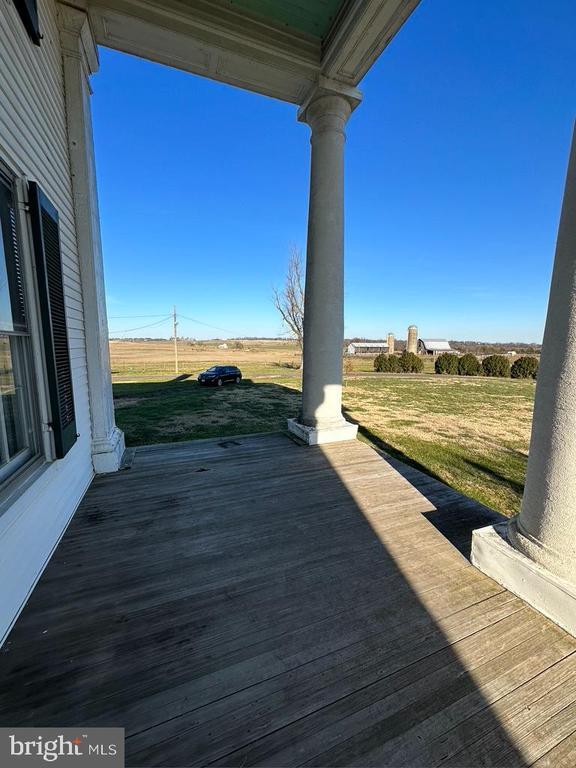 wooden terrace featuring a lawn
