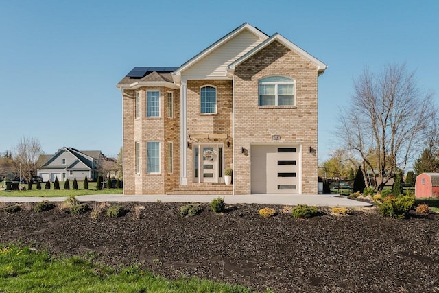 728 Mason St, Dayton, VA 22821 - traditional-style house with roof mounted solar panels, an attached garage, and brick siding