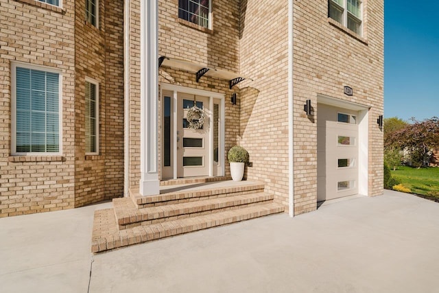 728 Mason St, Dayton, VA 22821 - property entrance featuring an attached garage, driveway, and brick siding