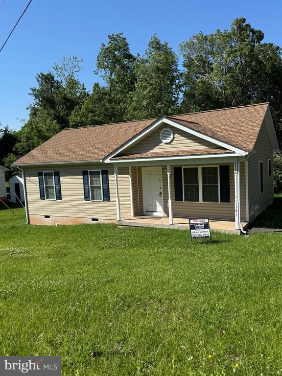view of front of property with crawl space, roof with shingles, and a front lawn
