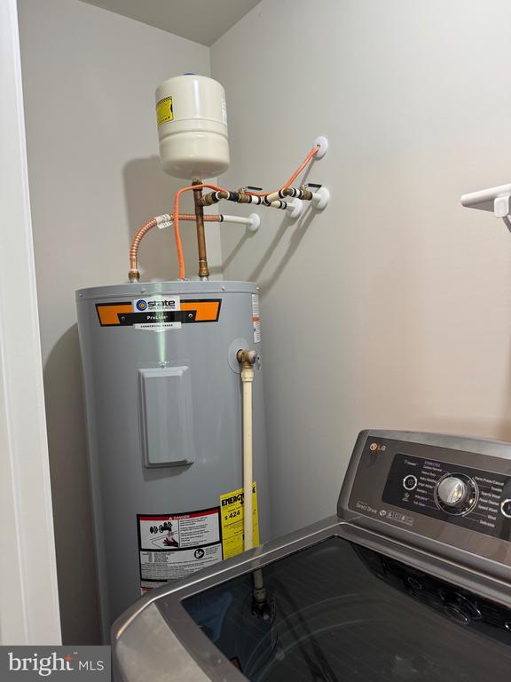 utility room featuring water heater and washer / clothes dryer