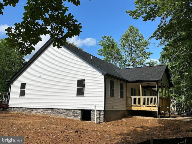 view of property exterior featuring a shingled roof