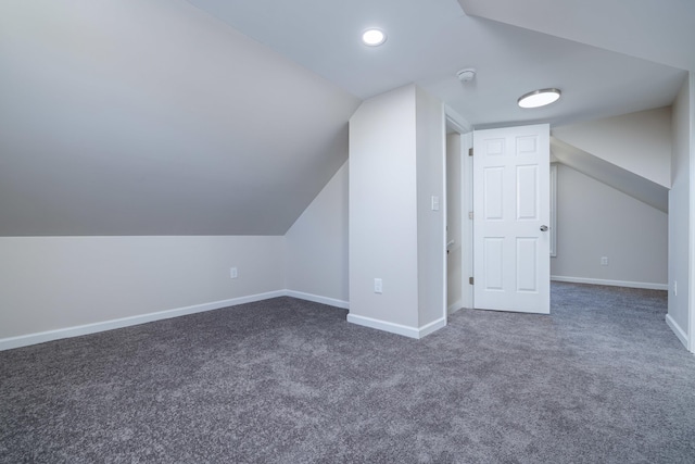 bonus room featuring lofted ceiling, baseboards, and carpet floors