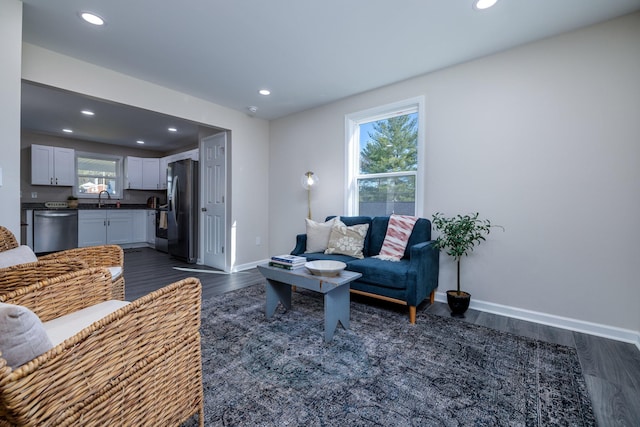 living room with baseboards, dark wood-style flooring, and recessed lighting