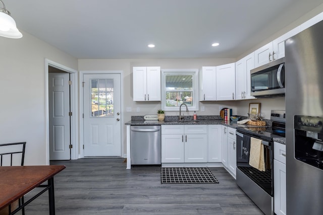 kitchen featuring recessed lighting, a sink, white cabinetry, appliances with stainless steel finishes, and dark wood-style floors