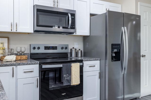 kitchen featuring white cabinetry, dark stone counters, and appliances with stainless steel finishes
