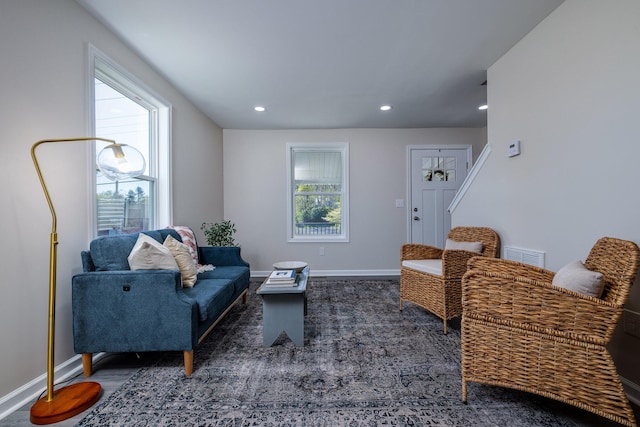 living area with wood finished floors, baseboards, visible vents, and recessed lighting