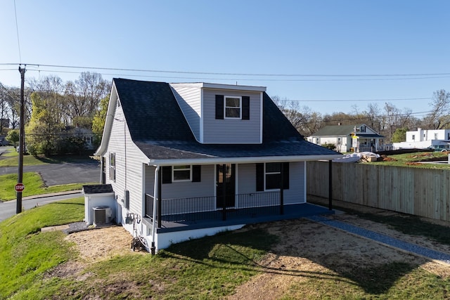 bungalow with a porch, fence, a front lawn, cooling unit, and a shingled roof