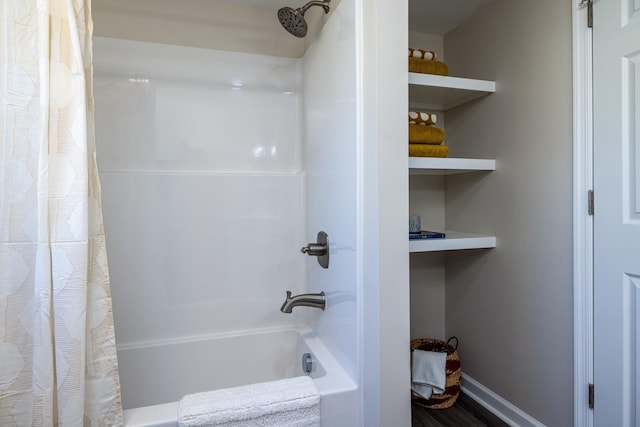 full bathroom with baseboards and shower / tub combo with curtain