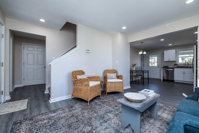 living room featuring baseboards, dark wood-style floors, and recessed lighting