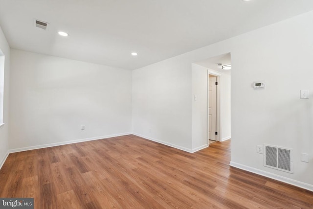 unfurnished room featuring wood finished floors, baseboards, and recessed lighting
