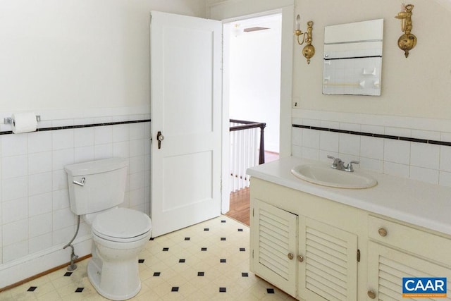 2201 Stadium Rd, Charlottesville, VA 22903 - half bath with tile walls, vanity, tile patterned floors, and a wainscoted wall