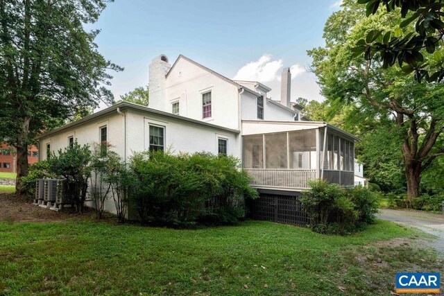 2201 Stadium Rd, Charlottesville, VA 22903 - view of property exterior featuring a chimney, a sunroom, stucco siding, and a yard