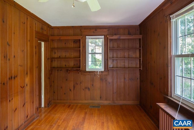 2201 Stadium Rd, Charlottesville, VA 22903 - empty room featuring wood walls, wood finished floors, and a ceiling fan