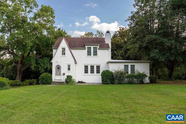 2201 Stadium Rd, Charlottesville, VA 22903 - tudor-style house with a front lawn, stucco siding, and a chimney