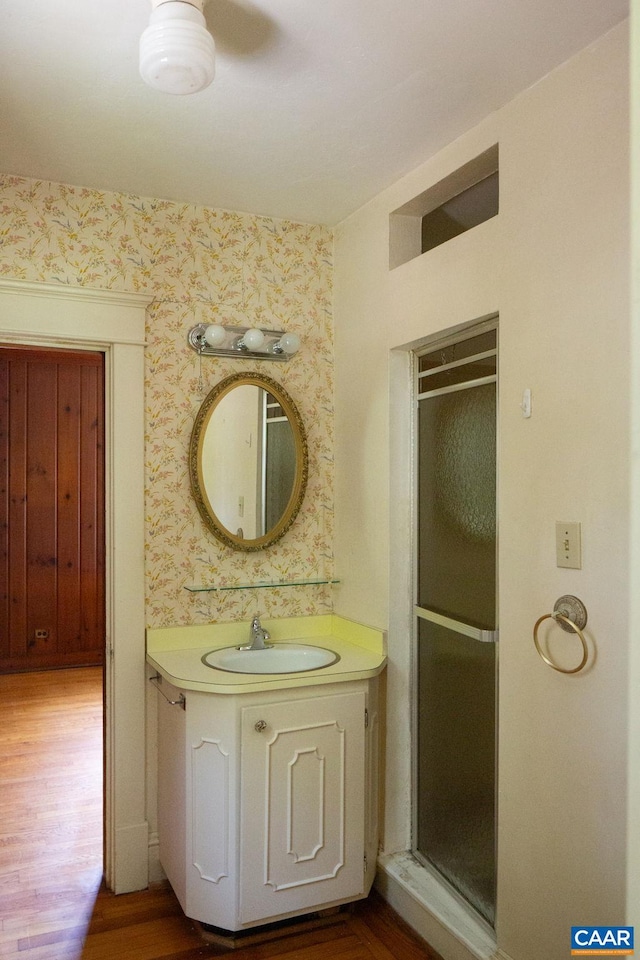 2201 Stadium Rd, Charlottesville, VA 22903 - full bathroom featuring wallpapered walls, vanity, a shower stall, and wood finished floors