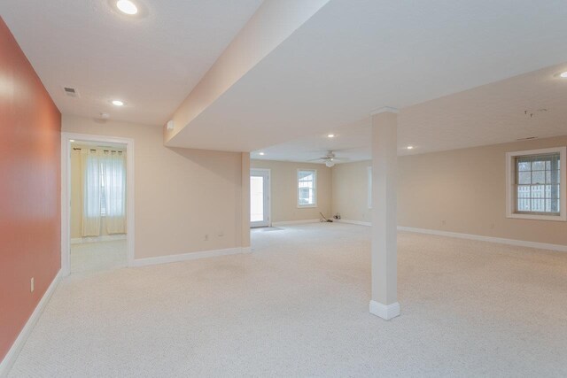 basement featuring light carpet