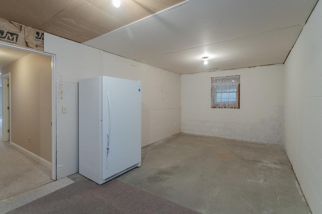 basement featuring white refrigerator