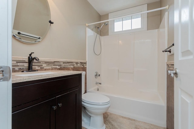 full bathroom with tile walls, tile patterned flooring, vanity, shower / bathtub combination, and toilet