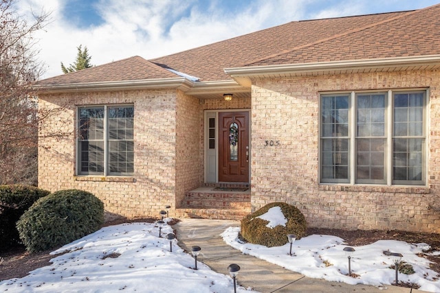 view of snow covered property entrance