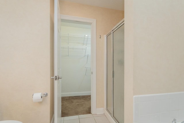 bathroom featuring tile patterned floors and an enclosed shower