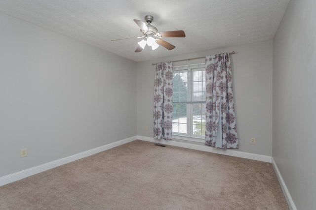 unfurnished room featuring ceiling fan, carpet, and a textured ceiling