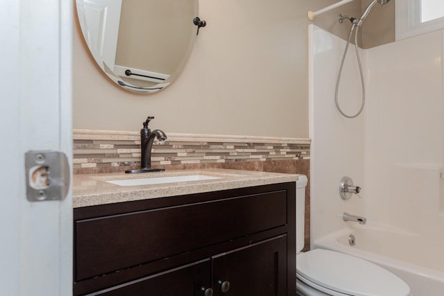 full bathroom with vanity, shower / tub combination, tile walls, and toilet