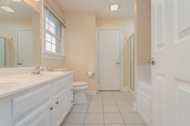 bathroom featuring tile patterned floors, toilet, a shower with shower door, and vanity