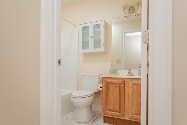 bathroom featuring vanity, toilet, and tile patterned flooring