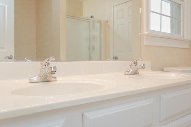 bathroom featuring vanity, an enclosed shower, and toilet