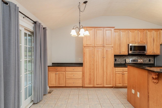 kitchen featuring lofted ceiling, hanging light fixtures, light tile patterned floors, stainless steel appliances, and decorative backsplash