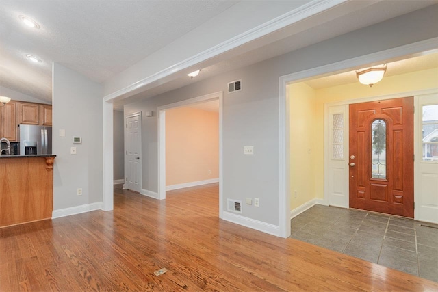 foyer entrance featuring dark hardwood / wood-style flooring and sink