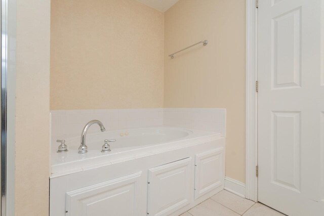 bathroom featuring a bath and tile patterned floors