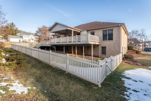 back of house featuring a balcony and a lawn