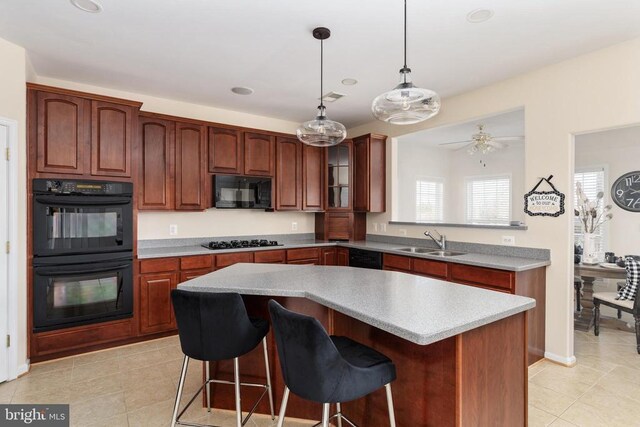 kitchen featuring black appliances, a sink, a center island, light tile patterned flooring, and recessed lighting