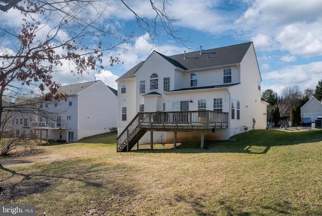 rear view of property with a deck, a yard, and stairway