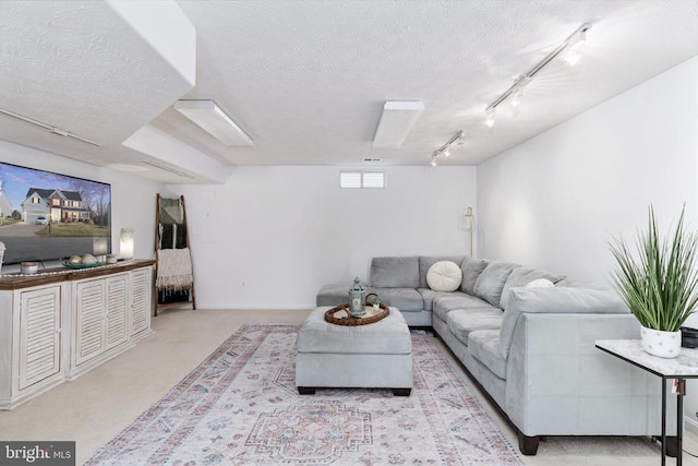 living room featuring rail lighting, a textured ceiling, and carpet floors