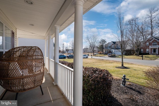 balcony featuring covered porch and a residential view