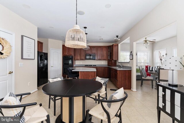 dining space with a ceiling fan, light tile patterned floors, and baseboards