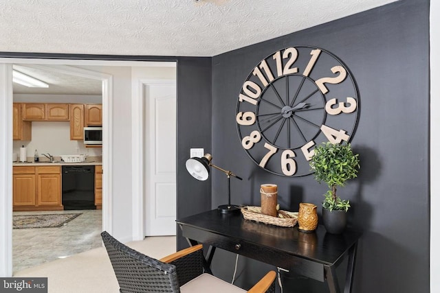 interior space with black dishwasher, a textured ceiling, and a sink
