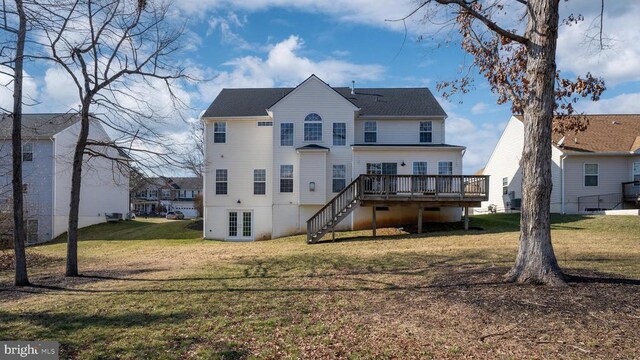 rear view of house with french doors, a deck, a yard, and stairway