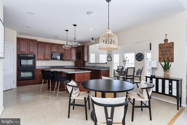 dining space with recessed lighting and light tile patterned flooring