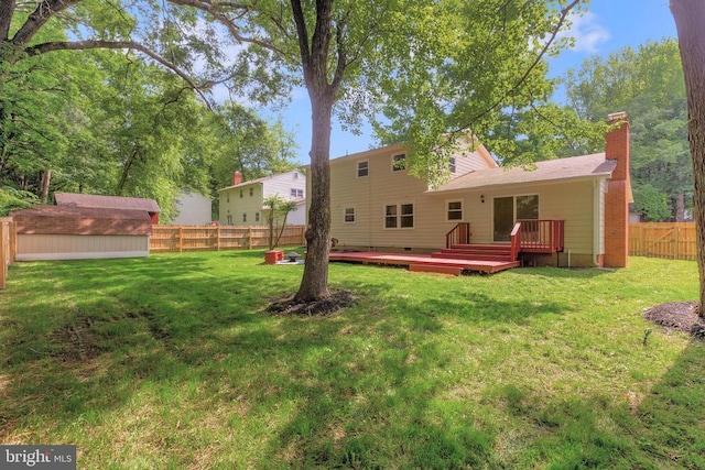 11808 Rutherford Dr, Fredericksburg, VA 22407 - rear view of house with a fenced backyard, a deck, and a chimney