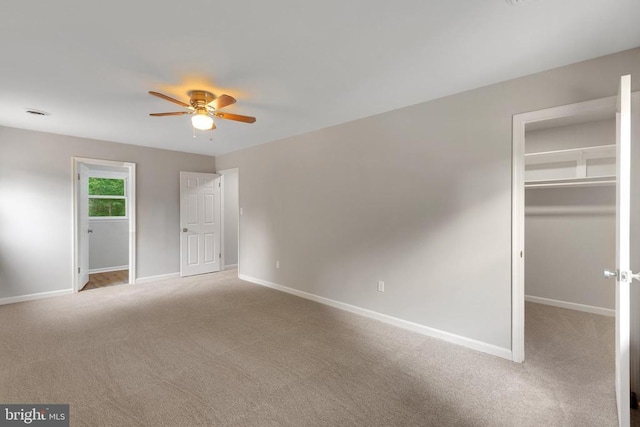 11808 Rutherford Dr, Fredericksburg, VA 22407 - unfurnished bedroom featuring a walk in closet, carpet floors, a closet, and ceiling fan