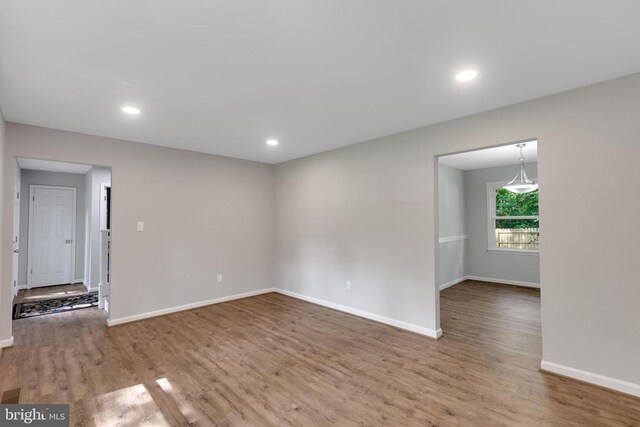 11808 Rutherford Dr, Fredericksburg, VA 22407 - unfurnished living room with wood finished floors, recessed lighting, and a brick fireplace