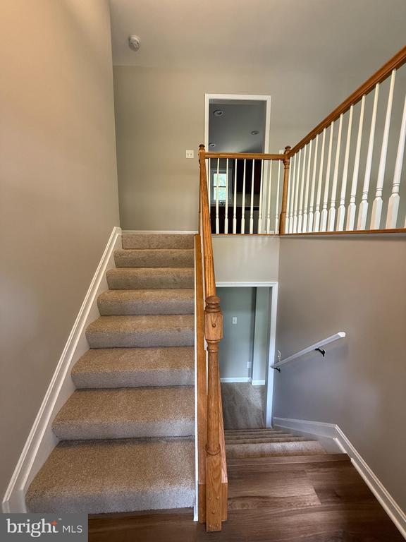 11503 Wilderness Park Dr, Spotsylvania, VA 22551 - stairway featuring wood finished floors and baseboards
