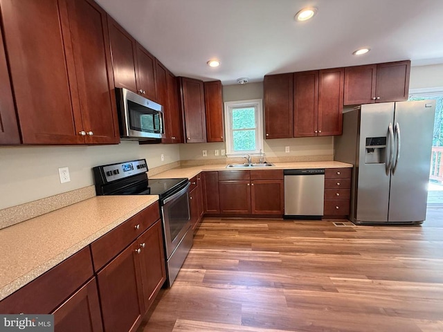 11503 Wilderness Park Dr, Spotsylvania, VA 22551 - kitchen featuring stainless steel appliances, a sink, light wood finished floors, light countertops, and recessed lighting