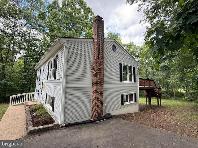 11503 Wilderness Park Dr, Spotsylvania, VA 22551 - view of side of property with a chimney and a wooden deck