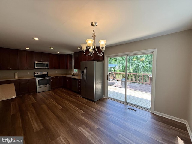 11503 Wilderness Park Dr, Spotsylvania, VA 22551 - kitchen featuring appliances with stainless steel finishes, a sink, a chandelier, light countertops, and dark wood-style floors